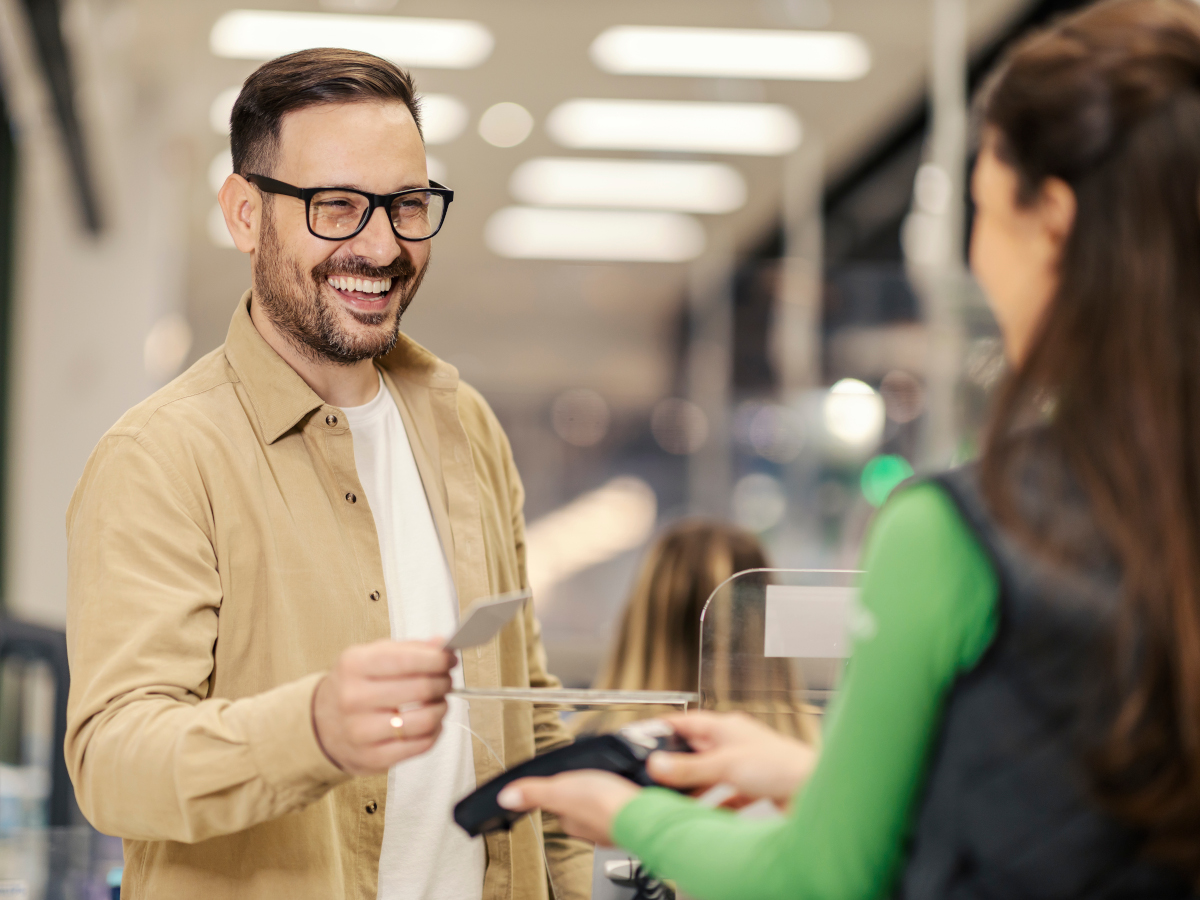 happy-man-checkout-is-paying-with-credit-card-pos-terminal (1)